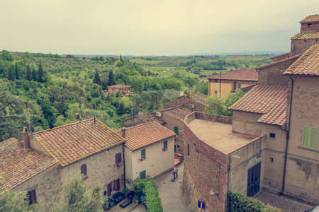 Rooftop view of tuscany countryside with traditional architecture and nature.の写真素材