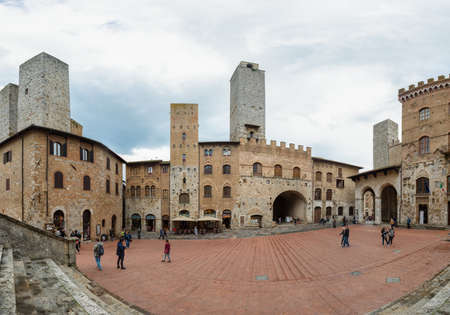 San Gimignano, Italy - May 3: Tourists exploring stony city of San Gimignano and its many towers, on May 3 2018 in San Gimignano, Italyのeditorial素材