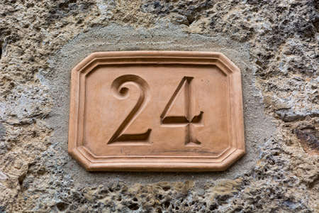 House number carved into clay tablet on facade.の写真素材