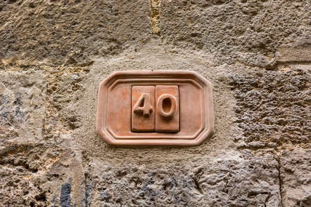 House number carved into clay tablet on facade.の写真素材