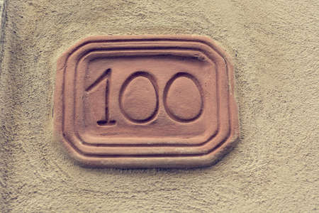 House number carved into clay tablet on facade.の写真素材