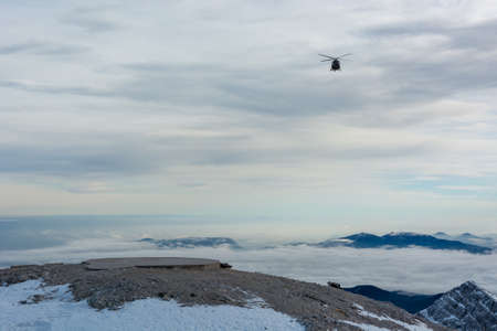 Mountain rescue helicopter landing to pick up wounded.の写真素材