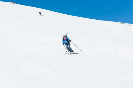 Female back-country skier tackling a steep slope.の写真素材
