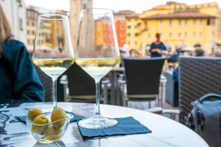 Outdoor street cafe table with finger food and local wine.の写真素材