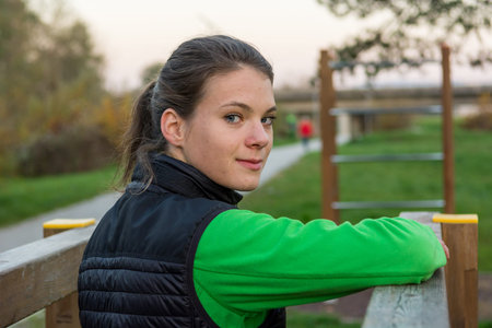 Athletic woman exercising at outdoor fitness in park.