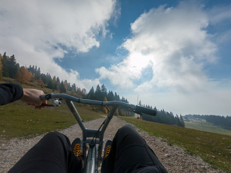 Driving a downhill buggy from person point of view.