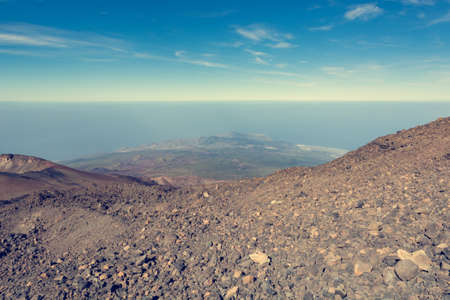 Panoramic view of volcanic landscape raising above sea level.の写真素材