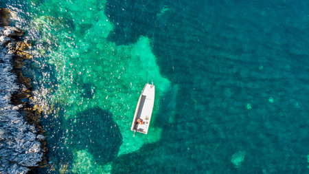 Drop down view of fishing boats anchored in bay.