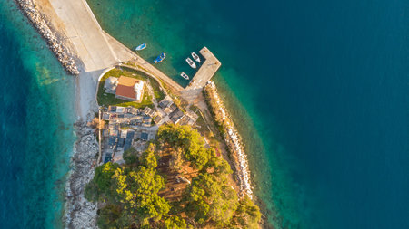 Drop down view of coastal village at sunset.