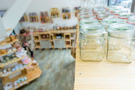 Closeup of empty glass jar in a zero waste shop.の写真素材