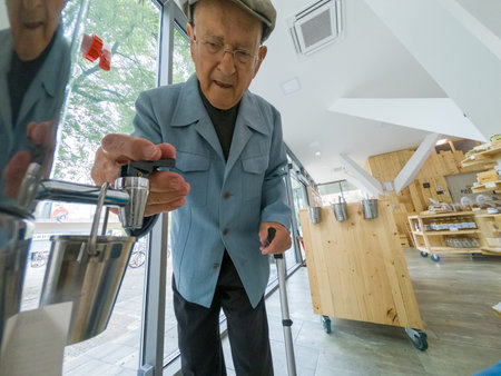 Elderly man looking at products at local organic zero waste store.の写真素材