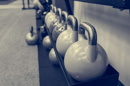 Colorful kettle bells in a row waiting for next exercise.の写真素材