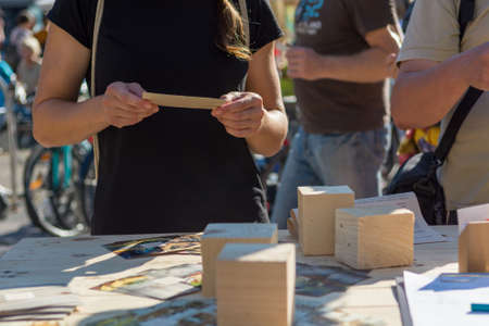 Female customer reading leaflet at outdoor market.の写真素材