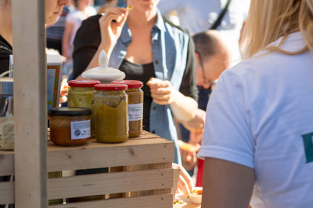 Serving customers at outdoor market with healthy local products.