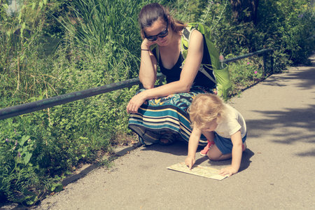 Mother and daughter looking at a map and planning which way to take.
