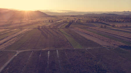 Aerial view of autumn fields at sunset.の写真素材