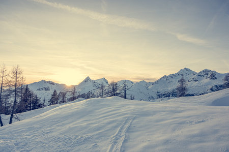 Spectacular winter mountain panoramic view of mountains at sunset.