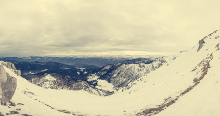 Spectacular winter mountain panoramic view of mountains with clouded sky. Pokljuka, Slovenia.