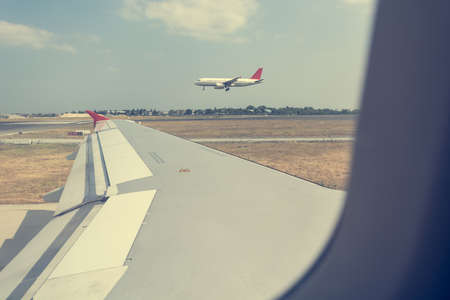 View through passanger view of an airliner at airport. Airplane landing.の写真素材