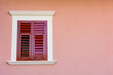 Detail of olf wooden window with closed shutters.