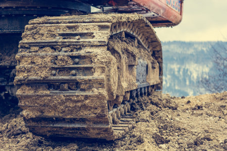 Tracks of a excavator machine on a construction site.