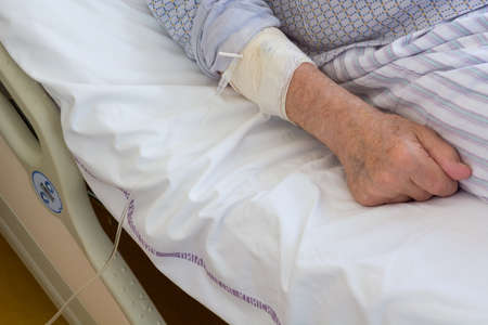Detail of elderly mans hand taking medicine into vein.の写真素材