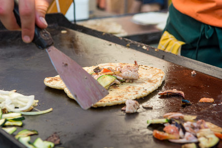 Cheff preparing traditional Mediterranean squid dish on a hot grill.の写真素材