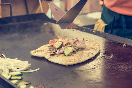 Cheff preparing traditional Mediterranean squid dish on a hot grill.の写真素材