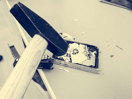 Destroying computer hard drive with a hammer. Removing important data.の写真素材