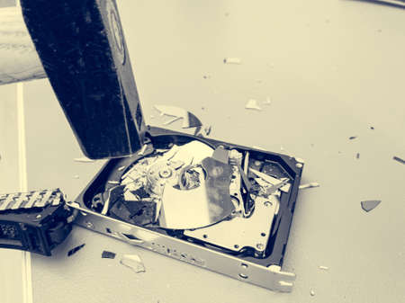Destroying computer hard drive with a hammer.の写真素材