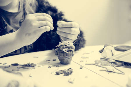 Detail of childs hand working with play dough.の写真素材