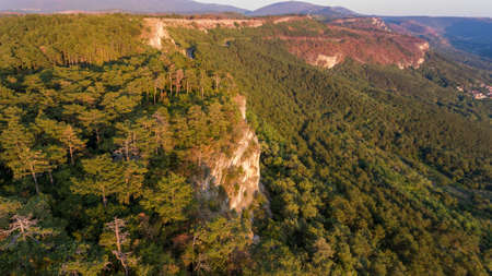Aerial view of forest gorwing right to the edge of a sheer cliff. Crni Kal, Slovenia.の写真素材