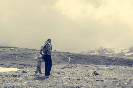 Mother and daughter hiking green alpine pastures.の写真素材