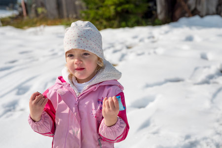 Portrait of a cute girl surrounded with snow.