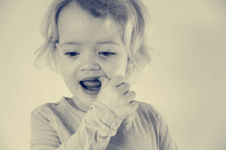 Portrait of cute blonde girl showing her teeth.の写真素材