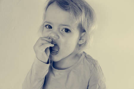 Portrait of cute blonde girl showing her teeth.の写真素材