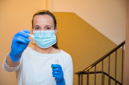 Medical nurse at aparment door with a swab for covid 19 general population testing at home address.