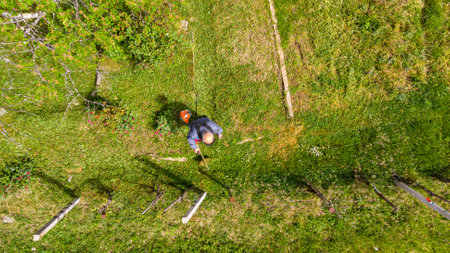 Drop down view of a person mowing lawn.の写真素材