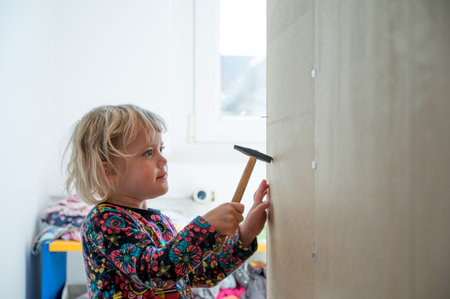 Cute blonde girl renovating her room building a closet.