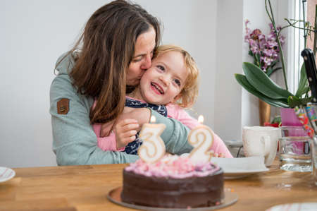 Mother and daughter celebrating birhday at home.の写真素材