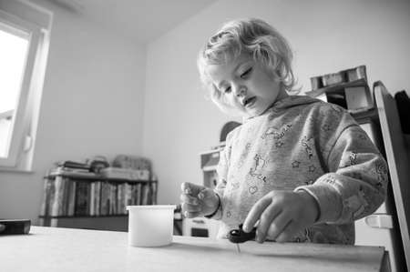 Cute blonde girl renovating her room building a closet.の写真素材