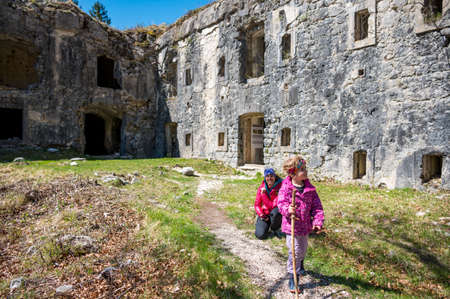 Mother and daughter posing in front of ruins of first world war fortress.の写真素材