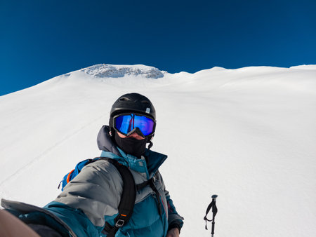 Active off piste skier taking a selfie on fresh powder slopes.の写真素材