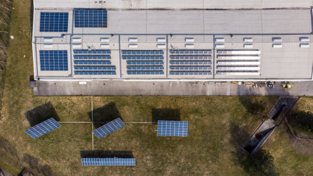 Drop down view of solar power plant with panels placed on industrial roof tops.の写真素材