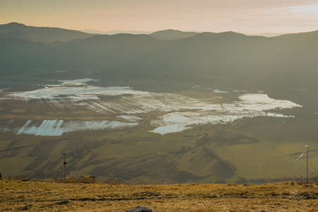 Majestic panoramic view from the top of the Slivnica mountain over the Cerknica lake in Slovenia on a warm autumn day.の写真素材