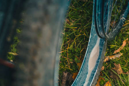 Defect on the mountain bike - flat tire of a tubeless setup exposing the white milk or sealant of a mtb tyre.の写真素材