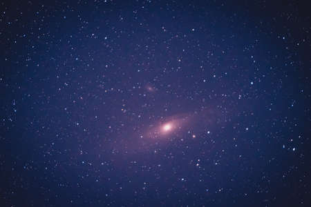 Real astronomical photo of andromeda galaxy taken with a 200mm camera on a clear sky with a long exposure. Stack of five pictures of andromeda galaxy.の写真素材