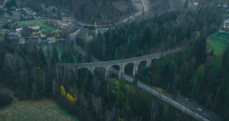 Magical aerial panorama of mystical Glebce viaduct close to Wisla, Poland in late autumn weather. Mysterious train bridge.の写真素材