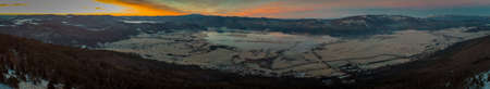 Early morning panorama of Cerknica lake viewed from above from Slivnica vantage point during sunrise. Beautiful sunrise photo of cerknica lake.の写真素材