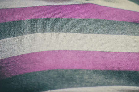 Detail of a fabric of a sweater in three colors - white, gray and pink.  Woven fabric in soft focus.の写真素材